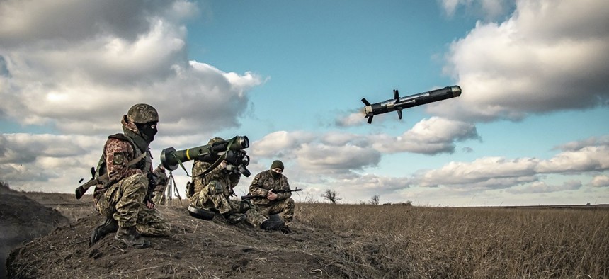 In this image released by Ukrainian Defense Ministry Press Service, Ukrainian soldiers use a launcher with US Javelin missiles during military exercises in Donetsk region, Ukraine, Dec. 23, 2021.