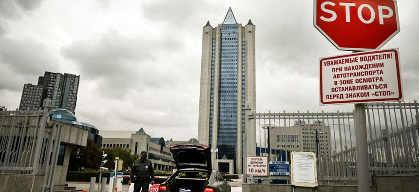 A security guard checks a car entering the grounds of the Moscow office of Russian gas giant Gazprom in Moscow on September 10, 2021.