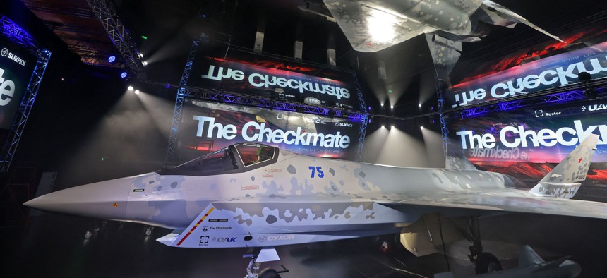 This picture taken on November 16, 2021 shows a view of the mockup and reflection of Russia's Sukhoi Su-75 "Checkmate" Light Tactical Aircraft on display during the 2021 Dubai Airshow.