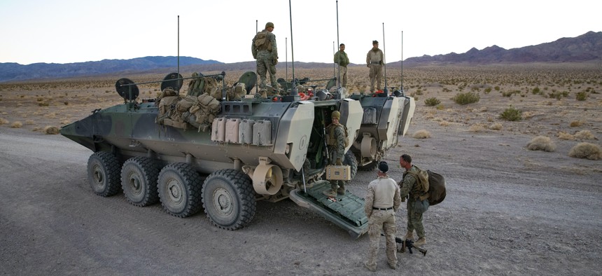 U.S. Marines with 3rd Assault Amphibian Battalion and 2nd Battalion, 7th Marine Regiment, 1st Marine Division begin unloading an Amphibious Combat Vehicle at the start of Marine Air Ground Task Force Warfighting Exercise 2-21 at Marine Corps Air Ground Combat Center, Twentynine Palms, Calif., Feb. 14, 2021.