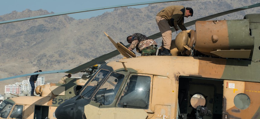 Afghan air force airmen perform preventive maintenance on Mi-17 helicopters, Dec 1, 2014, in Kabul, Afghanistan. 