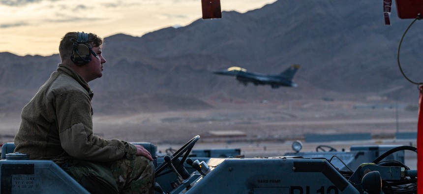 A maintainer assigned to Thunder Aircraft Maintenance Unit focuses on loading munitions onto the A-10 during the Load Crew of the Year Competition at Nellis Air Force Base, Nevada, Jan. 13, 2022. 