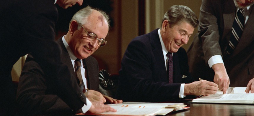 U.S. President Ronald Reagan and Soviet leader Mikhail Gorbachev signing the arms control agreement banning the use of intermediate-range nuclear missiles, the Intermediate Nuclear Forces Reduction Treaty, Washington DC, December 8, 1987.