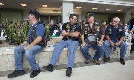 U.S. military veterans wait in the lobby area during the grand opening of a new Veteran's Administration VA Outpatient Clinic in southeast Austin, Texas, in 2013.
