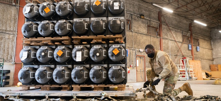 Airman 1st Class Olabode Igandan palletizes ammunition, weapons, and other equipment bound for Ukraine at Dover Air Force Base, Delaware, Jan. 21, 2022. 