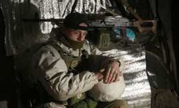 An Ukrainian Military Forces serviceman, looks on in a dugout on the frontline with Russia-backed separatists near Gorlivka, Donetsk region on January 23, 2022.