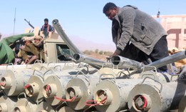 Yemeni pro-government fighters surround ordnance removed from the district of Harib on January 25, 2022, after Yemen's Houthi rebels were expelled from the key battleground district by UAE-trained Giants Brigade fighters. 