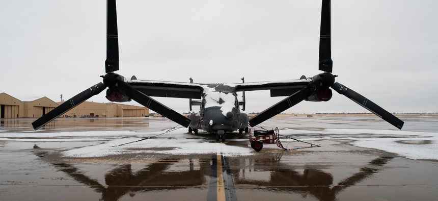 A CV-22 Osprey tiltrotor aircraft from the 20th Special Operations Squadron sits covered in snow on the flightline at Cannon Air Force Base, N.M., Jan. 26, 2022.