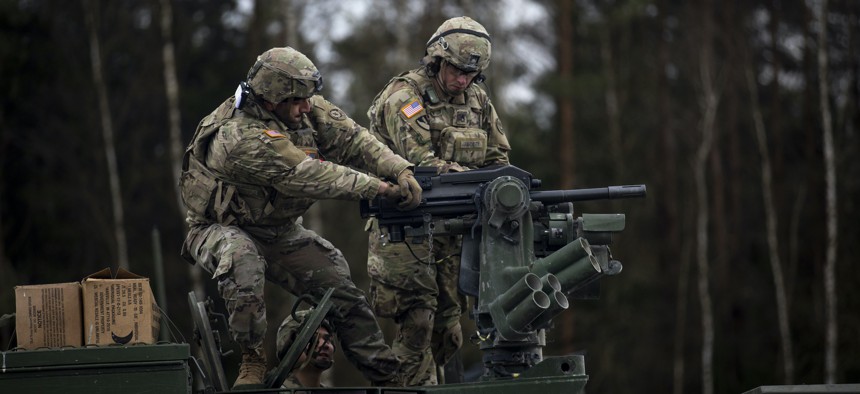 U.S. soldiers reload a MK-19 grenade launcher on a Stryker vehicle during a live-fire exercise at the 7th Army Training Command’s Grafenwoehr Training Area, Germany, Jan. 18, 2022.