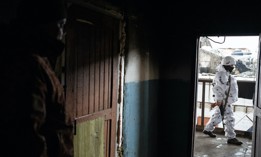 A Ukrainian soldier keeps guard at a building outside of Maryinka, Ukraine on February 2, 2022.
