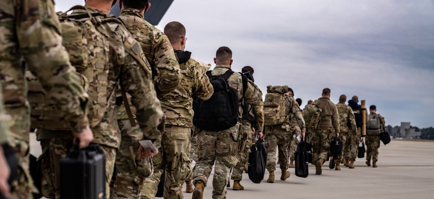 U.S. Army paratroopers assigned to the 82nd Airborne Division walk to their aircraft at Pope Army Airfield, N.C., on Feb. 8, 2022. 