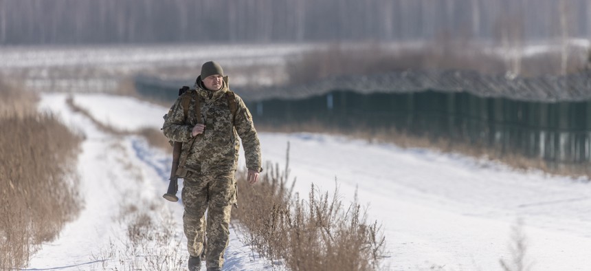 Members of the Ukrainian Border Guard patrol along the Ukrainian border fence at the Three Sisters border crossing between, Ukraine, Russia, and Belarus on February 14, 2022 in Senkivka, Ukraine. 