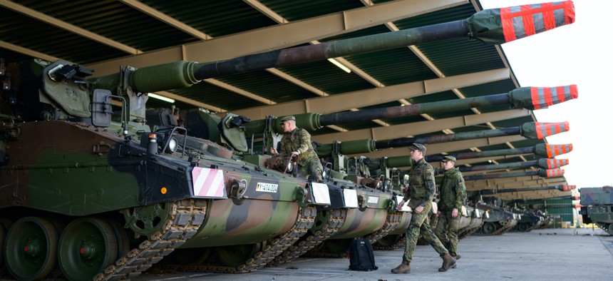 Six howitzers are prepared for their transport to Lithuania, as Germany sends around 350 troops to the Baltic states as reinforcements for the NATO battlegroup.