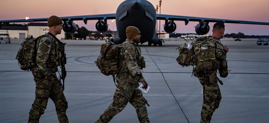 U.S. Army Paratroopers assigned to the 82nd Airborne Division walk to their aircraft at Pope Army Airfield, N.C. Feb. 14, 2022. 