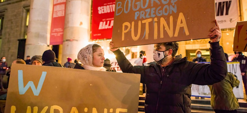 In Warsaw, protesters hold placards during a rally. "Warsaw in solidarity with Ukraine." Feb. 17, 2022