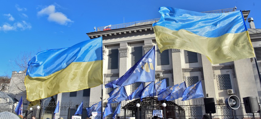 Ukrainian flags are pictured during a rally at the Embassy of the Russian Federation in Kyiv.