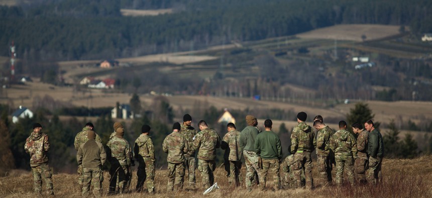 U.S. soldiers stand near the Ukrainian border near Arlamow, Poland, on February 24, 2022. 