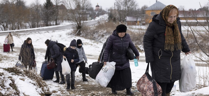 Refugees fleeing the Russian invasion make their way through western Ukraine to the Krakovets border crossing with Poland on March 9, 2022.