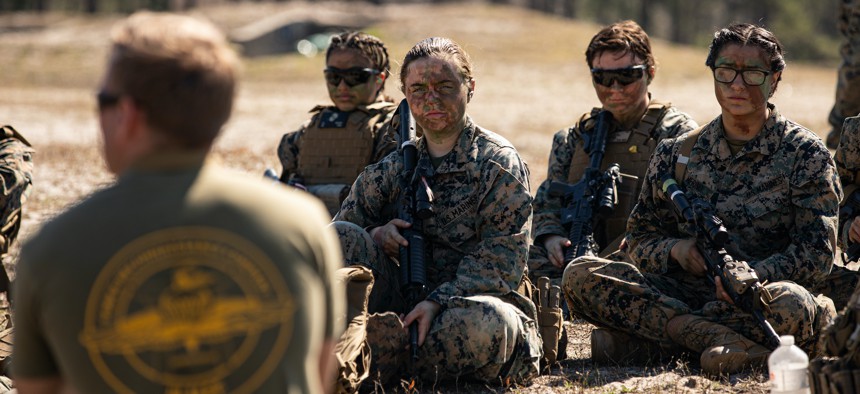 U.S. Marines with the Female Engagement Team attached to the 22nd Marine Expeditionary Unit participate in a brief during a live-fire training event aboard Marine Corps Base Camp Lejeune, N.C., March 2, 2022.