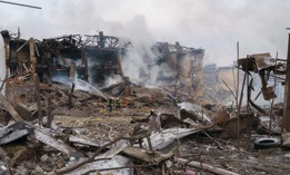 Firefighters spray water on a destroyed shoe factory following an airstrike in Dnipro, Ukraine, on March 11, 2022. 