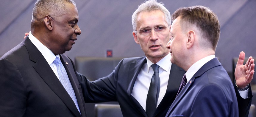 NATO Secretary General Jens Stoltenberg, US Defense Secretary Lloyd Austin (L) and Poland Defence Minister Mariusz Blaszczak (R) talk at the start of a round table as part of a NATO Defense Ministers' meeting over the Ukraine war at the alliance's headquarters in Brussels on March 16, 2022. (