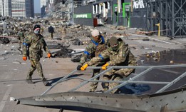 Ukrainian servicemen examine damage from a Russian air strike on a shopping mall in Kyiv, Ukraine, March 21, 2022.