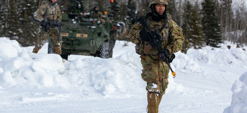 U.S. Army Spc. Renzo Marzo, an infantryman belonging to 3rd Battalion, 24th Infantry Regiment, 1st Stryker Brigade Combat Team, 25th Infantry Division, U.S. Army Alaska, advances through arctic terrain with his team during a field exercise in support of Joint Pacific Multinational Readiness Center 22-02 near Ft. Greely, AK, March 22, 2022.