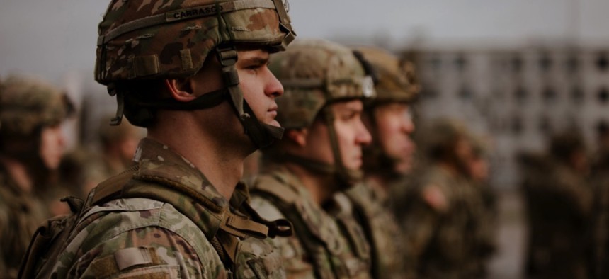 U.S. Army National Guard Soldiers assigned to 3rd Battalion, 161st Infantry Regiment, stand in formation during a handover/takeover ceremony at Bemowo Piskie Training Area, Poland, Feb. 11, 2022. 