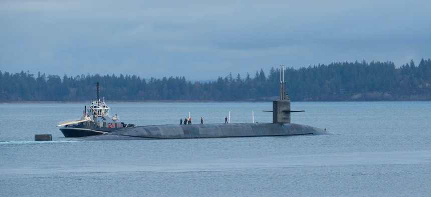 The Ohio-class ballistic missile submarine USS Nevada (SSBN 733) transits the Hood Canal as the boat departs its homeport of Naval Base Kitsap-Bangor, Washington, Dec. 16, 2021.