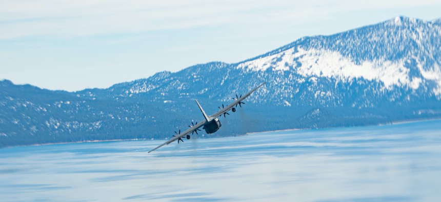 A Nevada Air National Guard C-130 Hercules aircraft flies over Lake Tahoe in a two-ship civic leader orientation flight, March 25, 2022.
