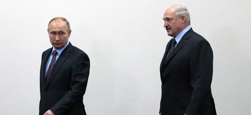 Russian President Vladimir Putin (L) and Belarussian President Alexander Lukashenko (R) enter the hall during their meeting on February 13, 2019 in Sochi, Russia.