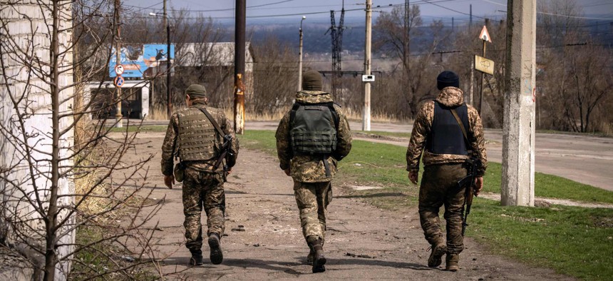 Ukrainian servicemen walk in the city of Severodonetsk, in the Donbass region of Ukraine, on April 6, 2022, as Ukraine tells residents in the country's east to evacuate "now" or "risk death" ahead of a feared Russian onslaught .