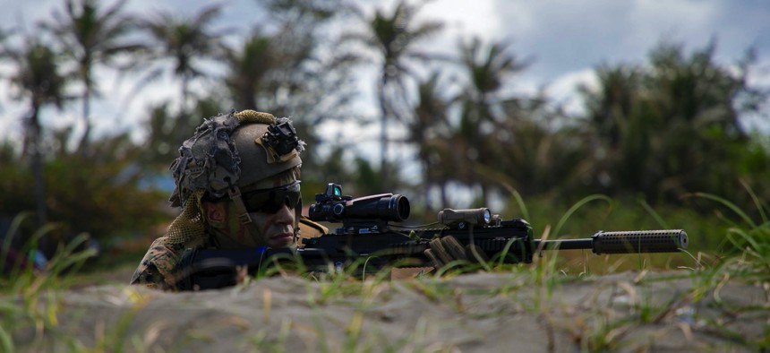 A Marine simulates providing security for an amphibious landing in Appari, Philippines, March 28, 2022, during Balikatan, a bilateral exercise between the U.S. and Philippines.