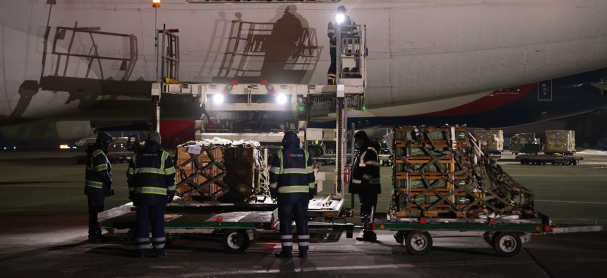 Ground personnel unload weapons, including Javelin anti-tank missiles, and other military hardware delivered on a National Airlines plane by the United States military at Boryspil Airport near Kyiv on January 25, 2022 in Boryspil, Ukraine. 