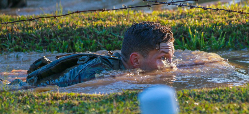 1st Lt. Joseph Martin from the 101st Airborne Division (Air Assault), low crawls under barbed wire in the Annual Best Ranger Competition in Fort Benning, Ga on April 8, 2022.