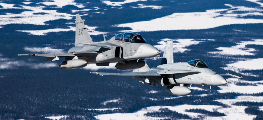 A Swedish Gripen jet and a Finnish F-18 Hornet take part in joint exercises over the Arctic Circle towns of Jokkmokk in Sweden and Rovaniemi in Finland on March 25, 2019.