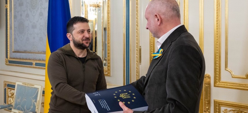Ukrainian President Volodymyr Zelenskyy (L) delivers the completed questionnaire to Matti Maasikas (R), Head of the EU Delegation to Ukraine, in order for his country to obtain candidate status for the European Union (EU) membership in Kyiv, Ukraine on April 18, 2022. 