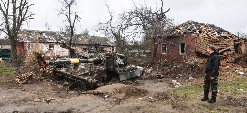 Destroyed Ukrainian tank surrounded by destroyed houses on the outskirts of Chernihiv on April 17, 2022.
