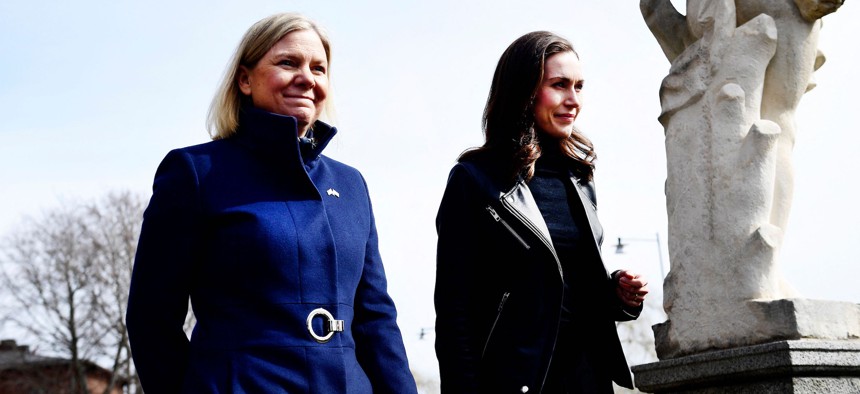 Swedish Prime Minister Magdalena Andersson (L) welcomes Finnish Prime Minister Sanna Marin prior to a meeting on whether to seek NATO membership in Stockholm, Sweden, on April 13, 2022.