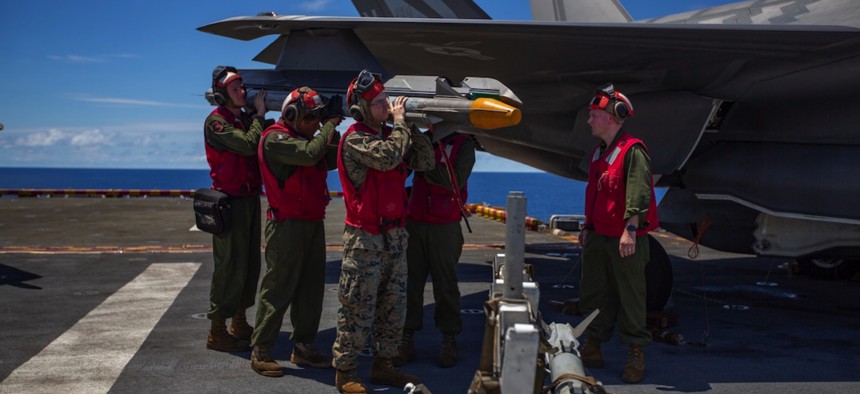 Marines with the 31st Marine Expeditionary Unit load an AIM-9X Sidewinder missile on an F-35B Lightning II aboard the amphibious assault ship USS Wasp in the Pacific Ocean in 2019.