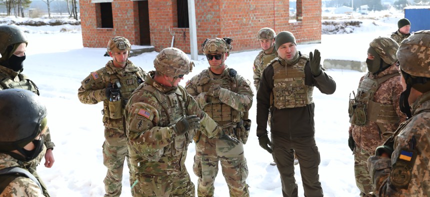 Sgt. 1st Class Jason Haigh of the Florida Army National Guard teaches tactics with Ukrainian observer controller/trainers at Ukraine's International Peacekeeping and Security Center on Feb. 3, 2022. 