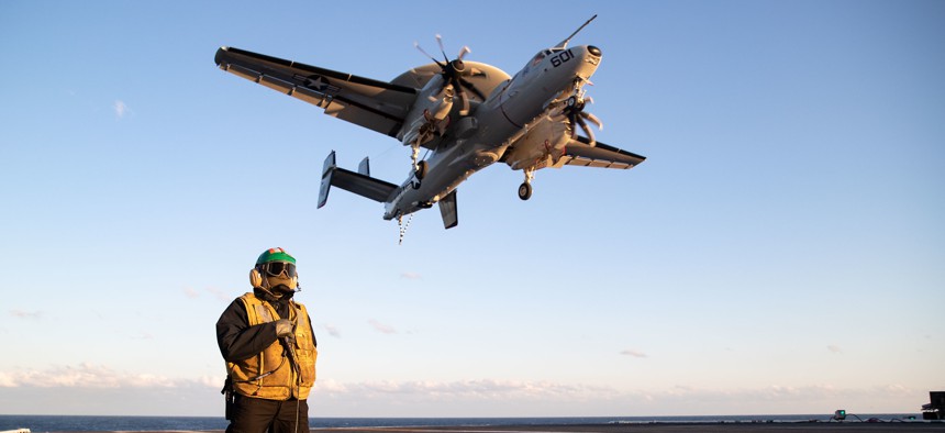 Aviation Boatswain's Mate (Equipment) 1st Class Aaron Wilson, from Atlanta, assigned to the air department aboard the aircraft carrier USS Gerald R. Ford (CVN 78), stands watch as the arresting gear officer as an E2-D Hawkeye attached to the "Bear Aces" of Airborne Command and Control Squadron (VAW) 124 flies over the flight deck, April 19, 2022.