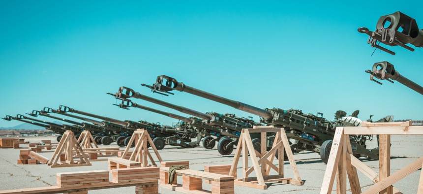 U.S. Marine Corps M777 155 mm howitzers are staged on the flight line prior to loading them into a U.S. Air Force C-17 Globemaster III aircraft at March Air Reserve Base, California, April 22, 2022.. The weapons were to be provided to Ukraine.