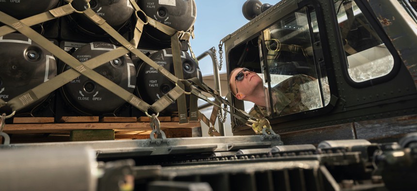 Airman 1st Class Stephen Knotts positions a cargo loader to an aircraft while loading military equipment bound for Ukraine, Feb. 10, 2022, at Dover Air Force Base, Del.