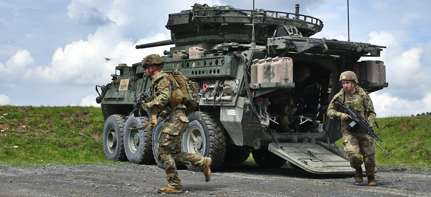 U.S. soldiers of the 2nd Cavalry Regiment dismount a Stryker vehicle during a situational training exercise at the 7th Army Training Command's Grafenwoehr Training Area, Germany, May 5, 2022.