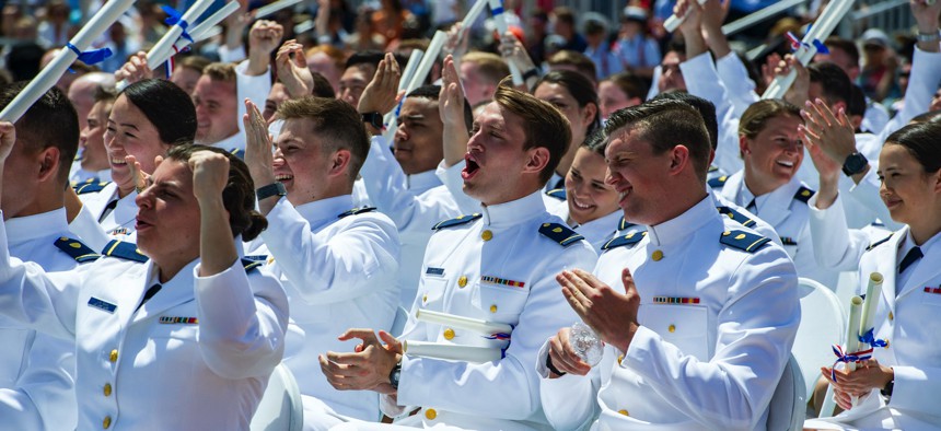 Newly commissioned officers congratulate each other and celebrate during the 141st Commencement Exercises of the United States Coast Guard Academy in New London, Connecticut, on May 18, 2022. 