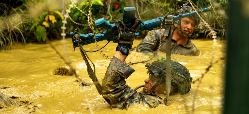 U.S. Marines with 3d Battalion, 2nd Marines, 3d Marine Division navigate an endurance course during a squad competition at the Jungle Warfare Training Center, Okinawa, Japan, May 26, 2022. 