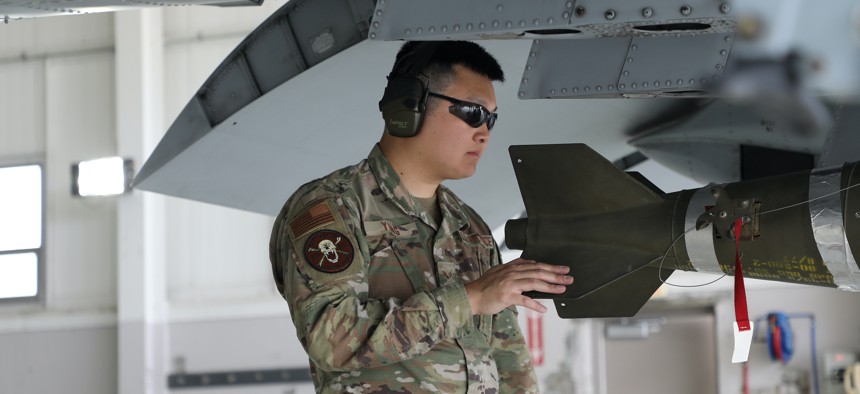 Senior Airman Kevin Yung of the 127th Aircraft Maintenance Squadron, loads GBU12 ammunition onto an A10 Thunderbolt II aircraft. 
