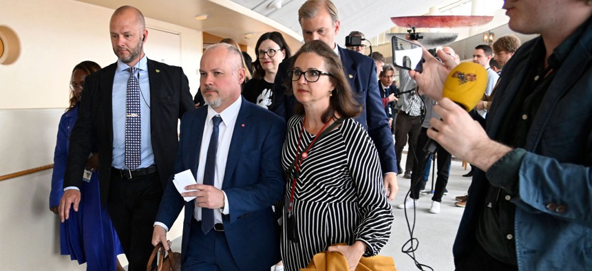 Minister for Justice and Home Affairs Morgan Johansson (2L) walks with Sweden's minister for Education and Research Anna Ekstrom after the no-confidence vote in Stockholm, on June 7, 2022. 
