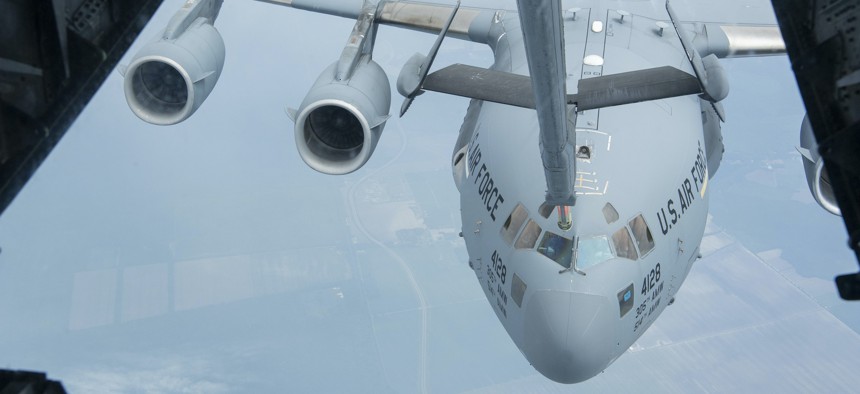 U.S. Air Force Senior Airman Caryl Armour, a boom operator with the 76th Air Refueling Squadron, 514th Air Mobility Wing, practices refueling a C-17 Globemaster III over the Eastern United States on June 8, 2022.